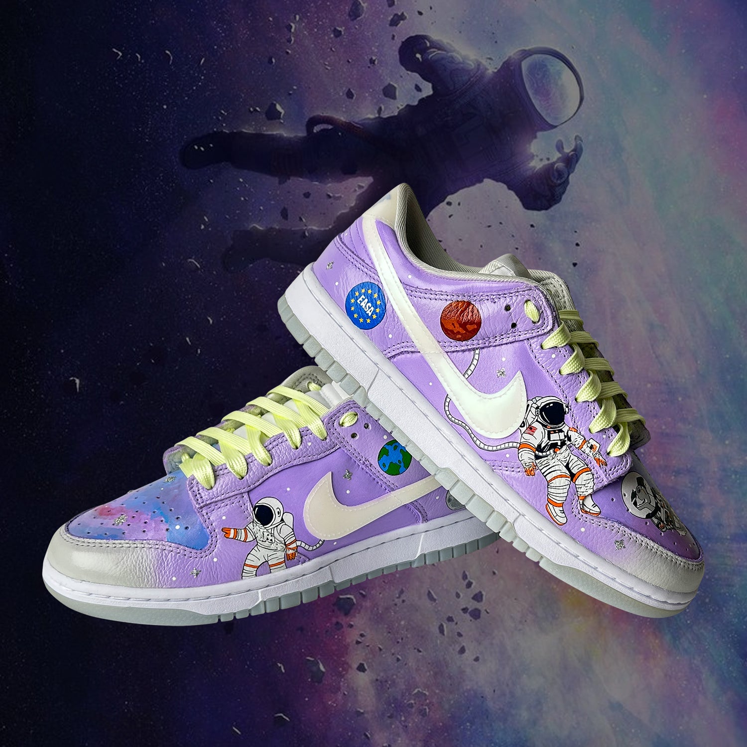 Pair of purple sneakers with astronaut design on a space-themed background